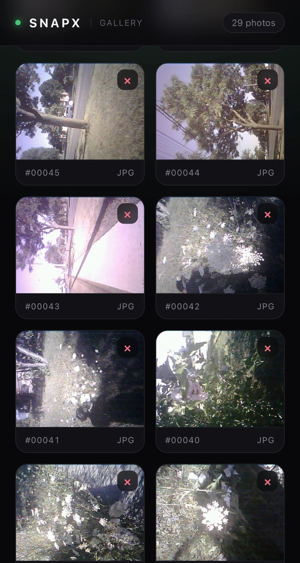 The SNAPX WiFi gallery open in a phone browser, showing a grid of photos taken by the camera